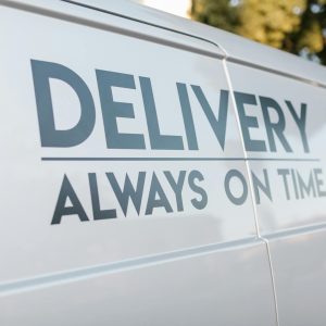 Close-up of delivery van with slogan 'Always On Time' emphasizing timely service.